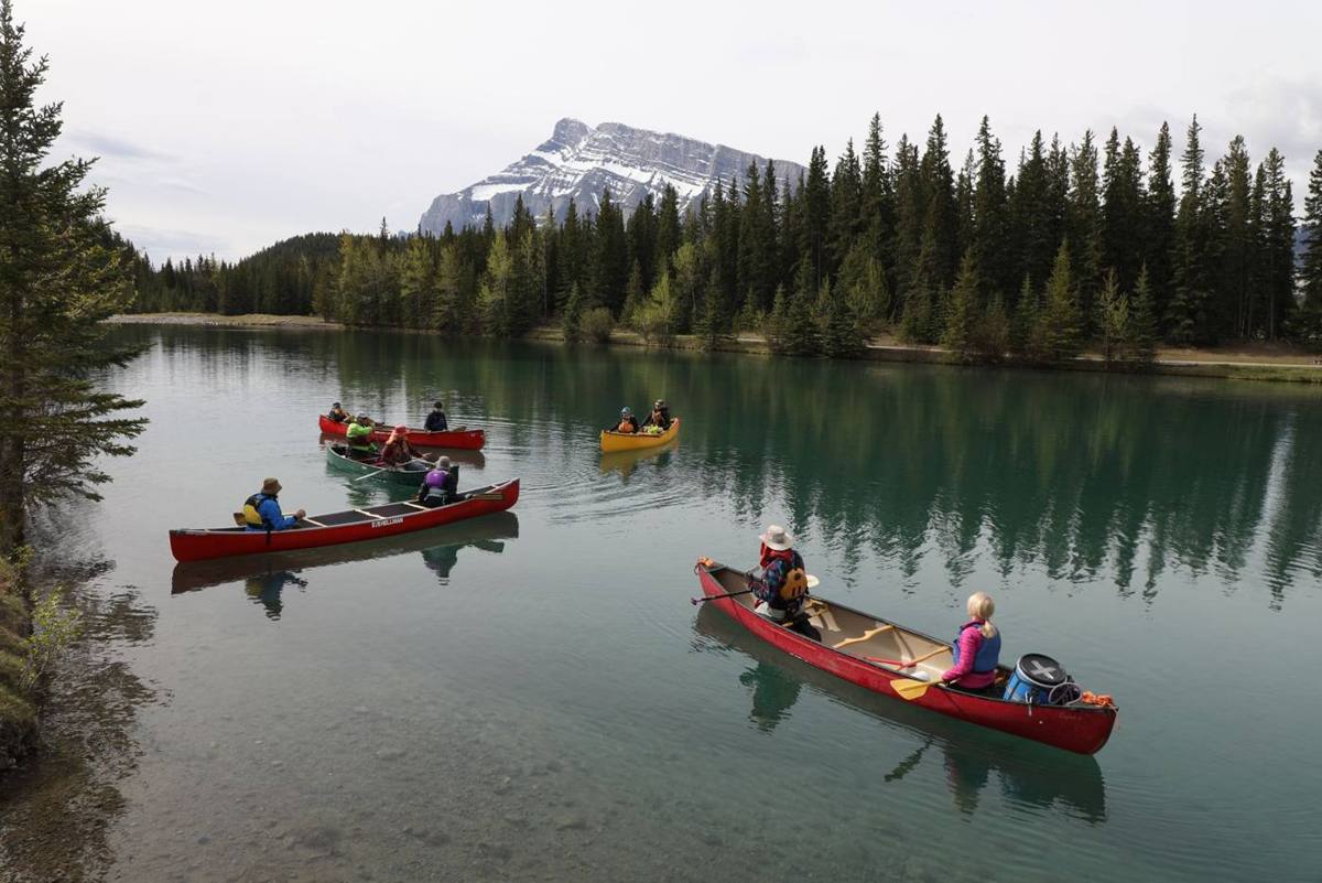 Red canoes on calm green water