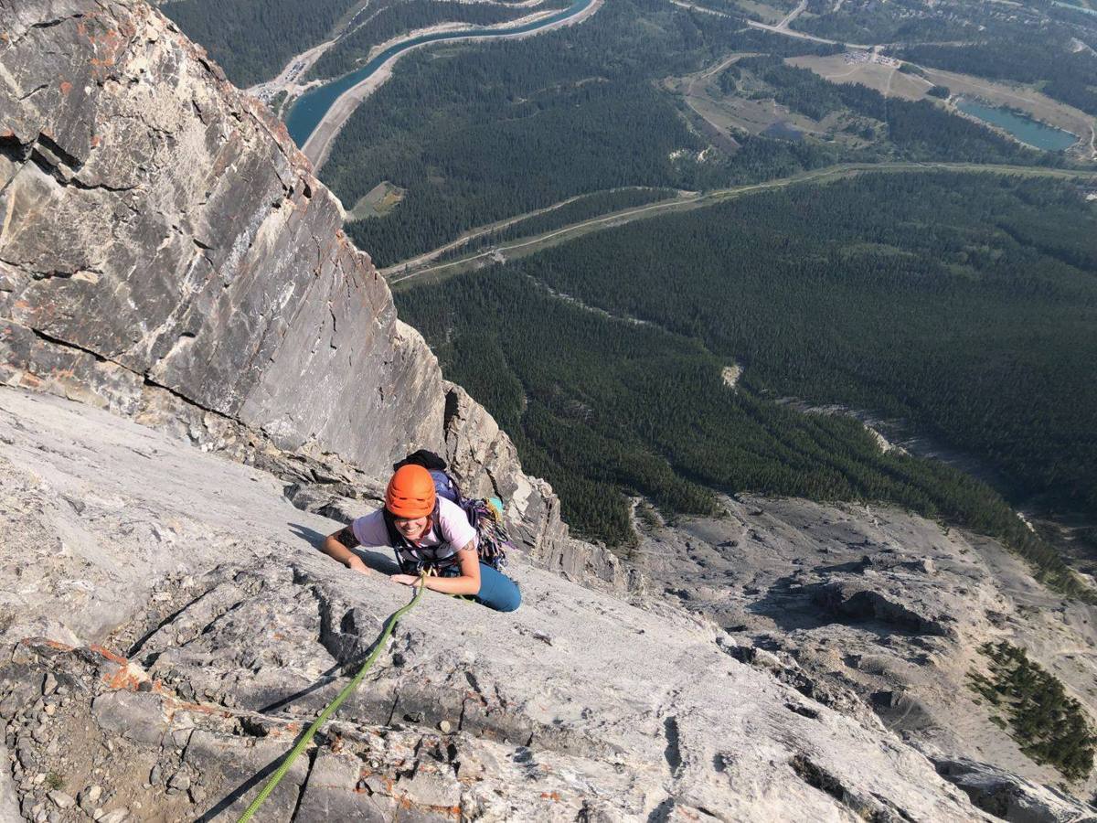 Climber on a limestone slab high above the valley