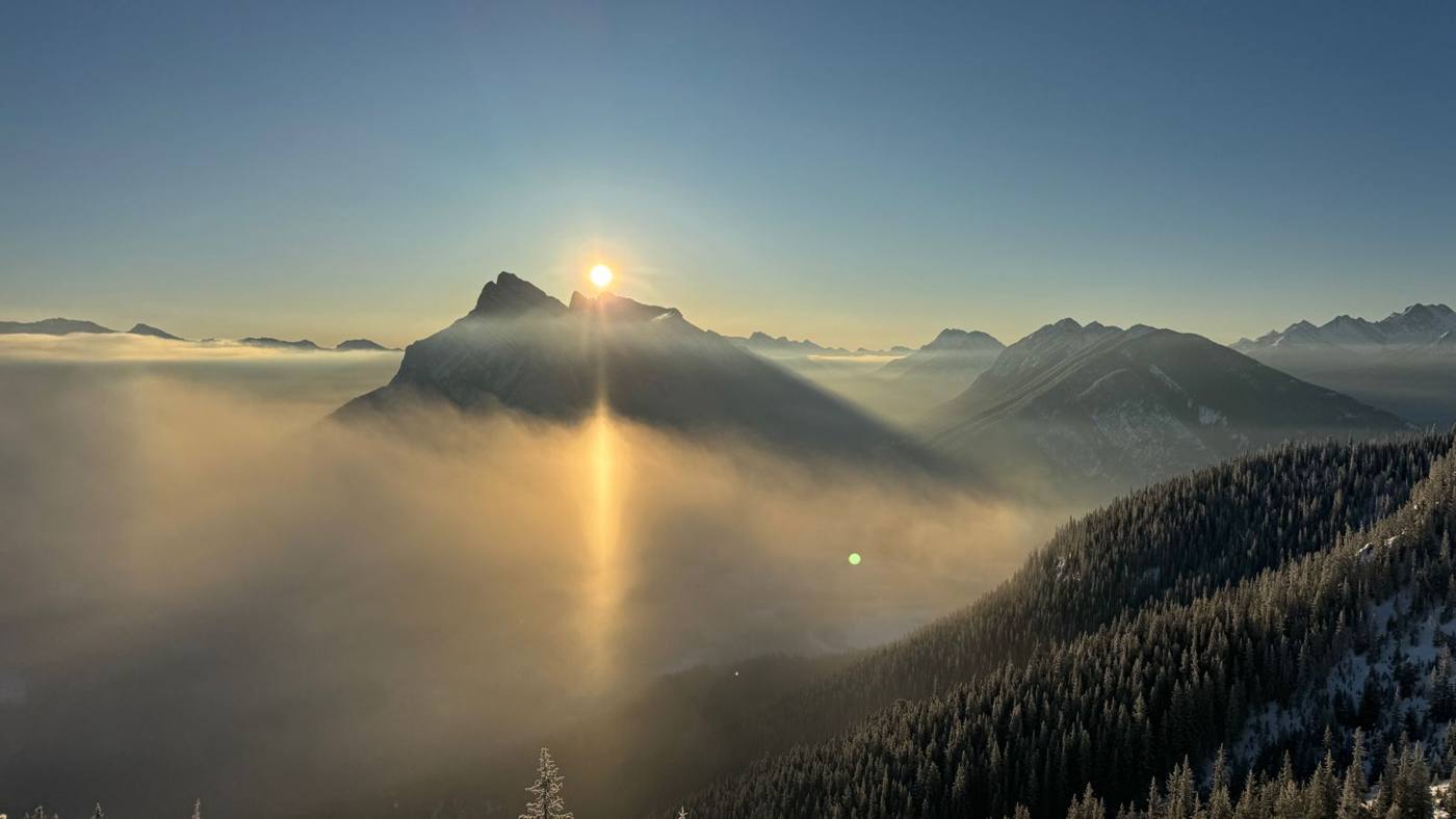 Sunrise over a cloud-filled valley
